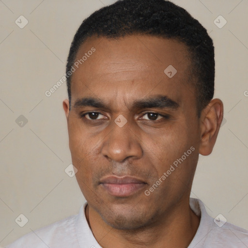 Joyful black young-adult male with short  black hair and brown eyes