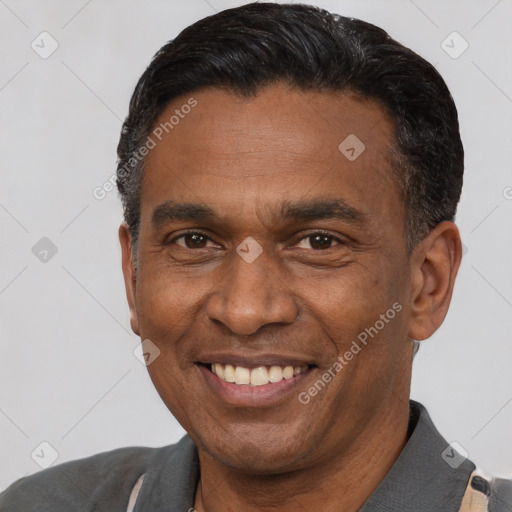 Joyful black adult male with short  black hair and brown eyes