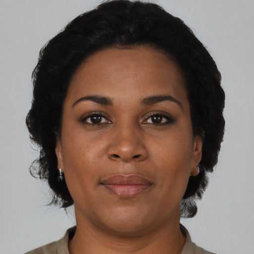 Joyful black adult female with short  brown hair and brown eyes
