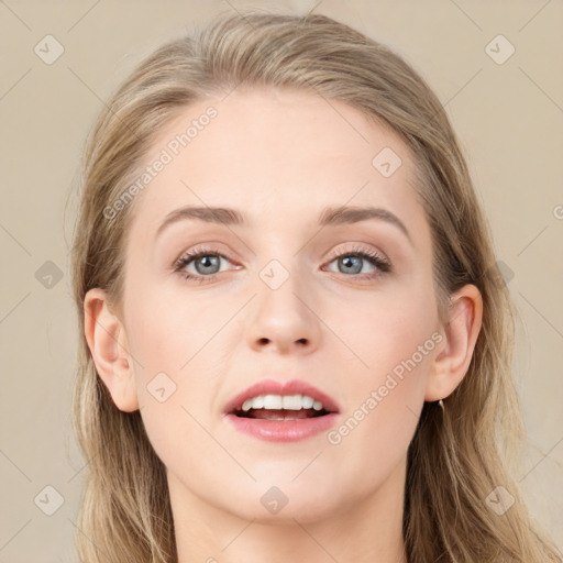 Joyful white young-adult female with long  brown hair and blue eyes