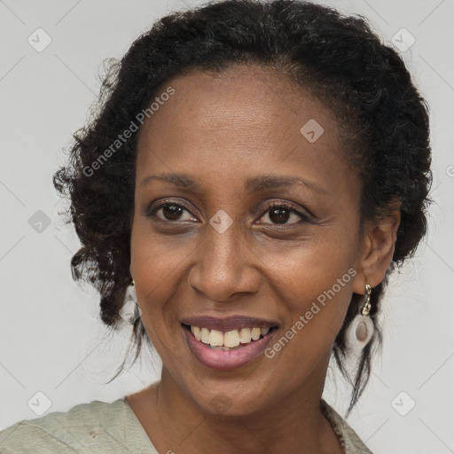 Joyful black adult female with medium  brown hair and brown eyes