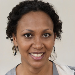 Joyful black adult female with short  brown hair and brown eyes