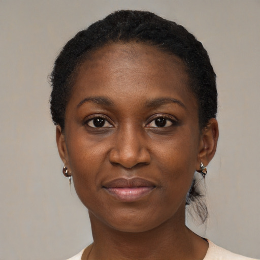 Joyful black adult female with short  black hair and brown eyes