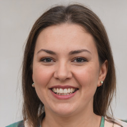 Joyful white young-adult female with medium  brown hair and grey eyes