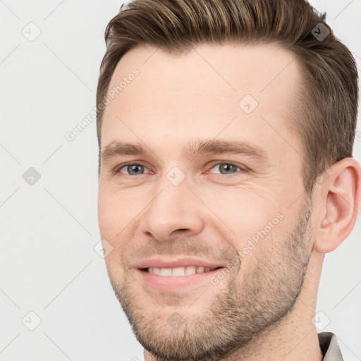 Joyful white young-adult male with short  brown hair and grey eyes