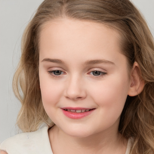 Joyful white child female with long  brown hair and brown eyes