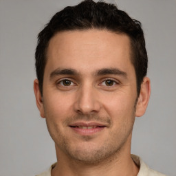 Joyful white young-adult male with short  brown hair and brown eyes