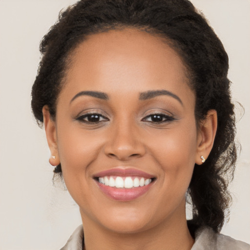 Joyful latino young-adult female with long  brown hair and brown eyes