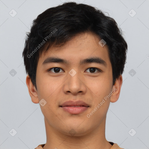 Joyful asian young-adult male with short  black hair and brown eyes