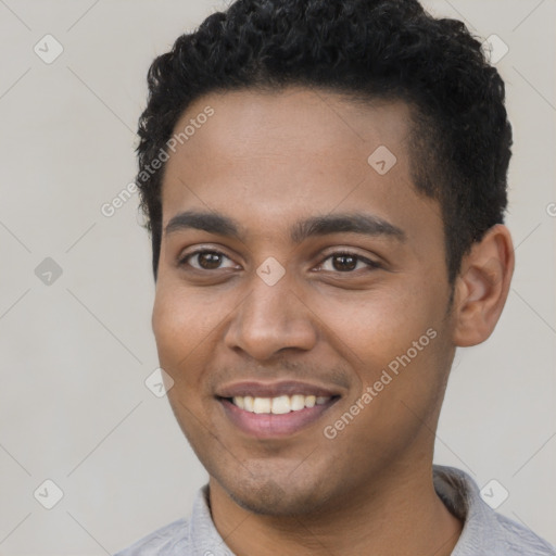 Joyful black young-adult male with short  black hair and brown eyes