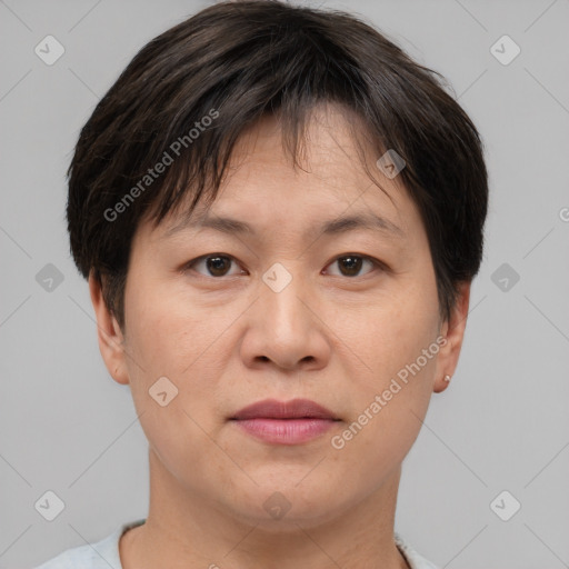 Joyful asian adult female with short  brown hair and brown eyes