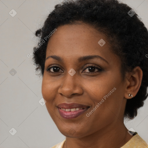 Joyful black adult female with short  brown hair and brown eyes