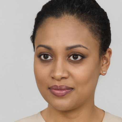 Joyful black young-adult female with short  brown hair and brown eyes