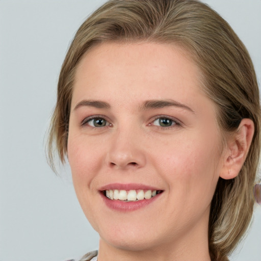 Joyful white young-adult female with medium  brown hair and blue eyes