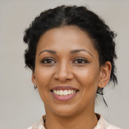 Joyful black young-adult female with medium  brown hair and brown eyes