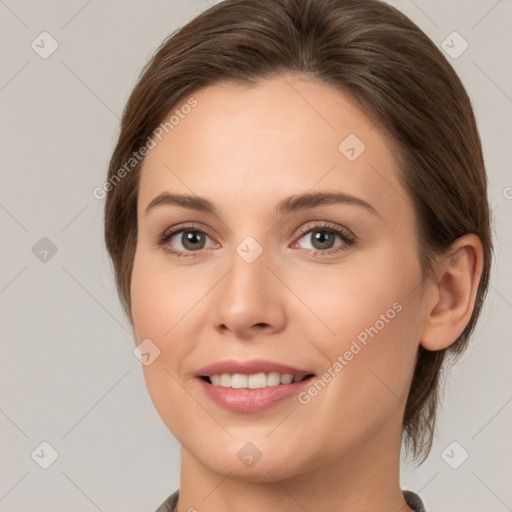 Joyful white young-adult female with medium  brown hair and grey eyes