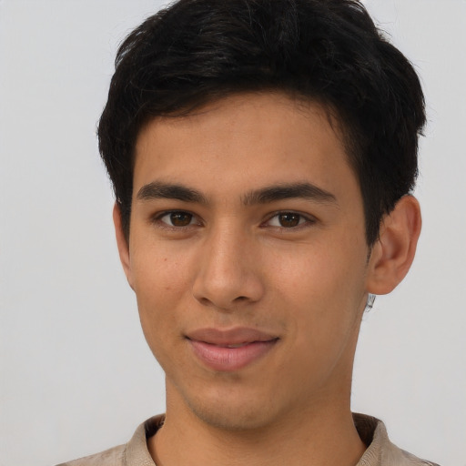 Joyful latino young-adult male with short  brown hair and brown eyes