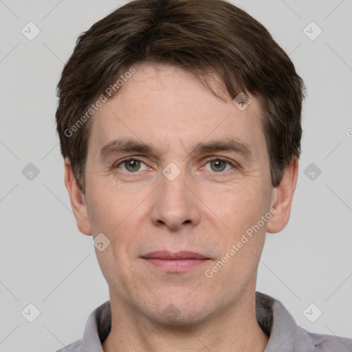 Joyful white adult male with short  brown hair and grey eyes