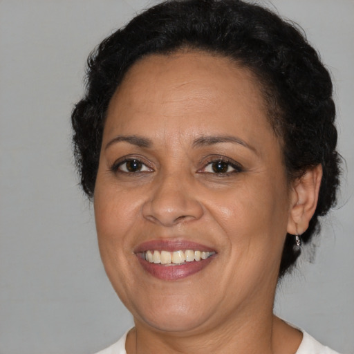 Joyful black adult female with short  brown hair and brown eyes