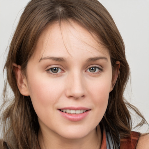 Joyful white young-adult female with long  brown hair and grey eyes