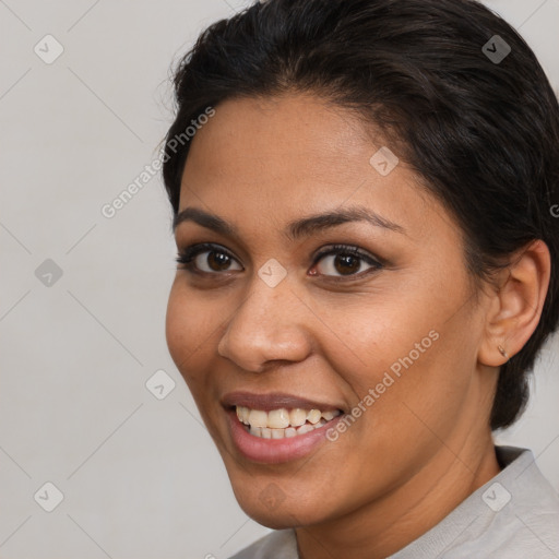 Joyful latino young-adult female with short  brown hair and brown eyes