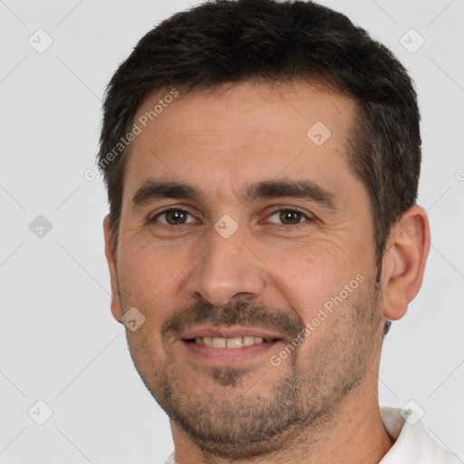 Joyful white adult male with short  brown hair and brown eyes