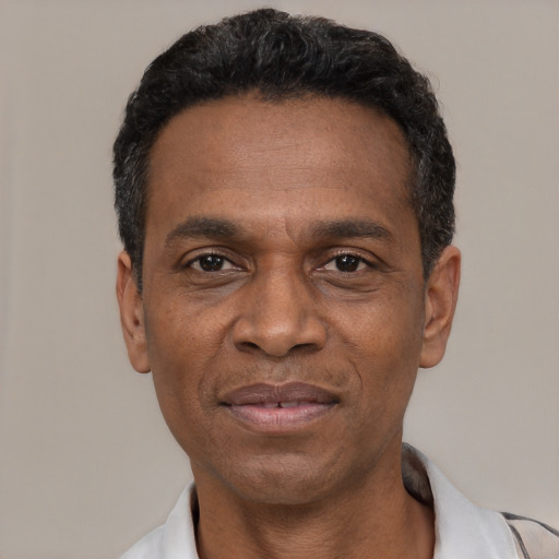 Joyful latino adult male with short  black hair and brown eyes