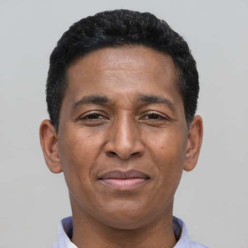 Joyful latino adult male with short  black hair and brown eyes