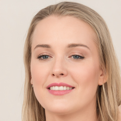 Joyful white young-adult female with long  brown hair and grey eyes