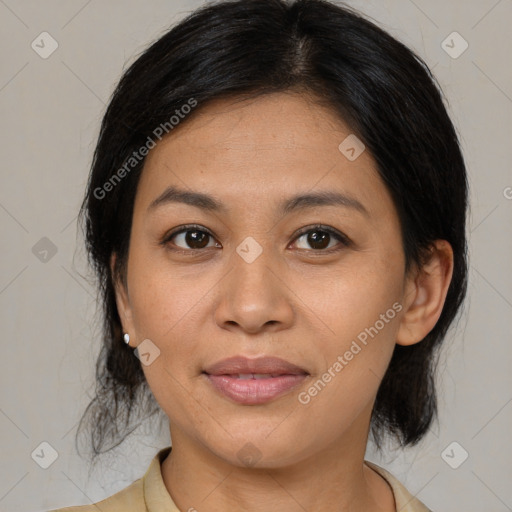 Joyful latino adult female with medium  brown hair and brown eyes