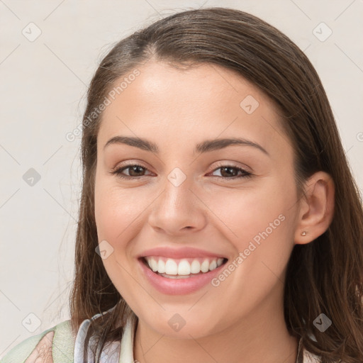 Joyful white young-adult female with long  brown hair and brown eyes