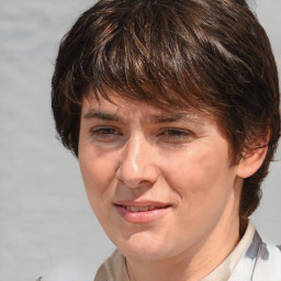 Joyful white adult female with medium  brown hair and brown eyes