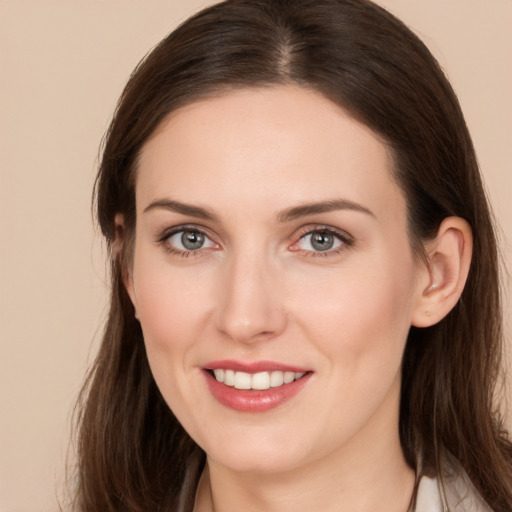 Joyful white young-adult female with long  brown hair and grey eyes