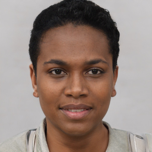 Joyful black young-adult female with short  black hair and brown eyes