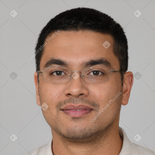 Joyful latino young-adult male with short  black hair and brown eyes