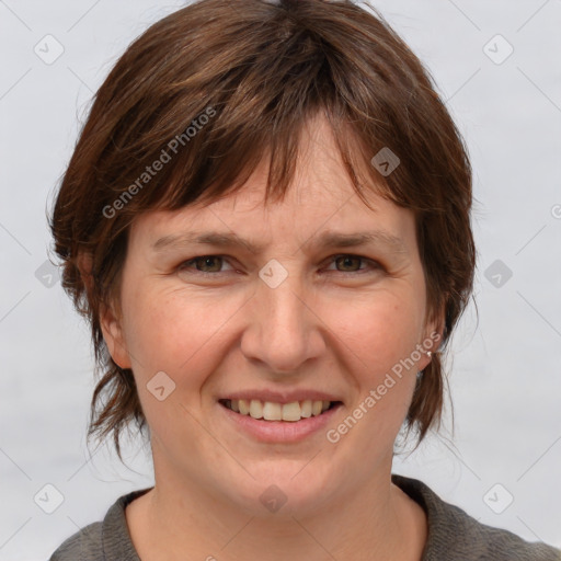 Joyful white adult female with medium  brown hair and grey eyes