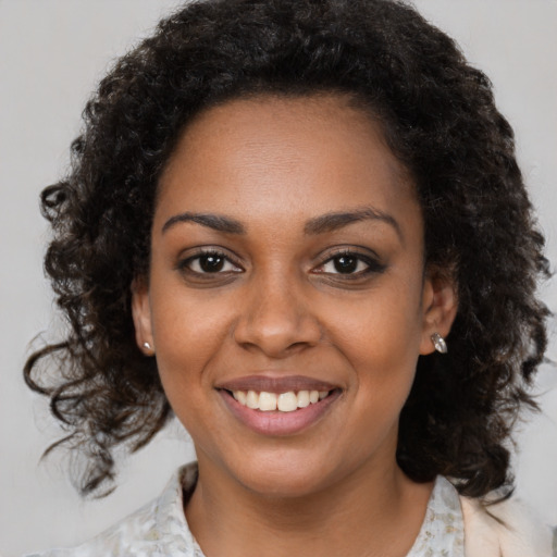 Joyful black young-adult female with medium  brown hair and brown eyes
