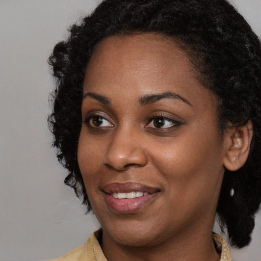 Joyful latino young-adult female with medium  black hair and brown eyes