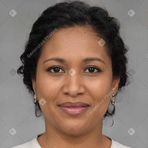 Joyful black adult female with medium  brown hair and brown eyes