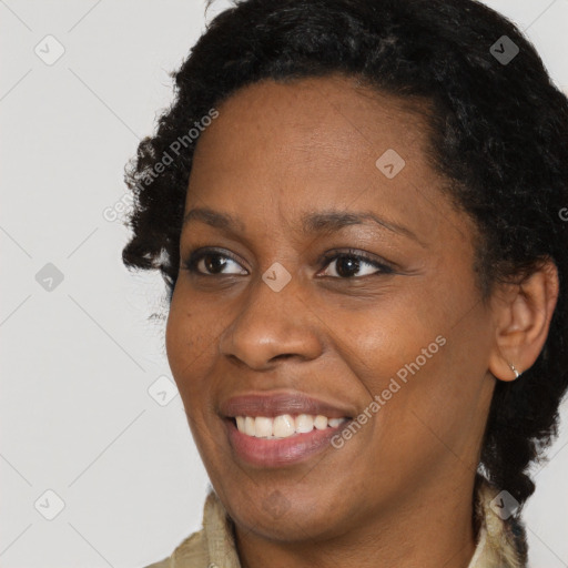 Joyful black adult female with short  brown hair and brown eyes