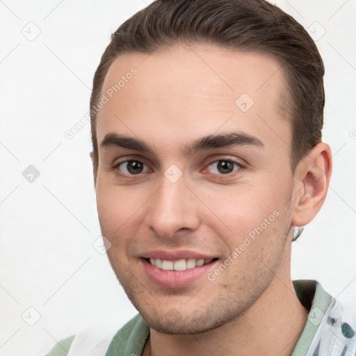 Joyful white young-adult male with short  brown hair and brown eyes