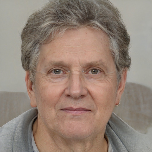 Joyful white middle-aged male with short  gray hair and brown eyes