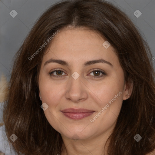 Joyful white adult female with long  brown hair and brown eyes