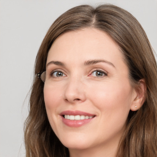 Joyful white young-adult female with long  brown hair and grey eyes