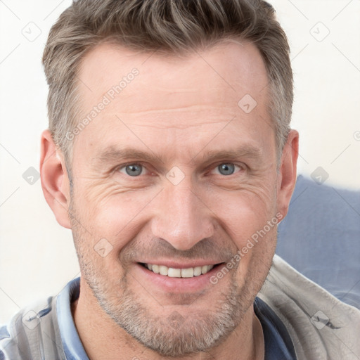 Joyful white adult male with short  brown hair and grey eyes