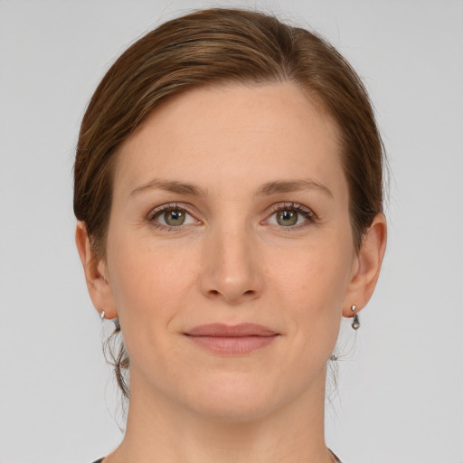 Joyful white young-adult female with medium  brown hair and green eyes