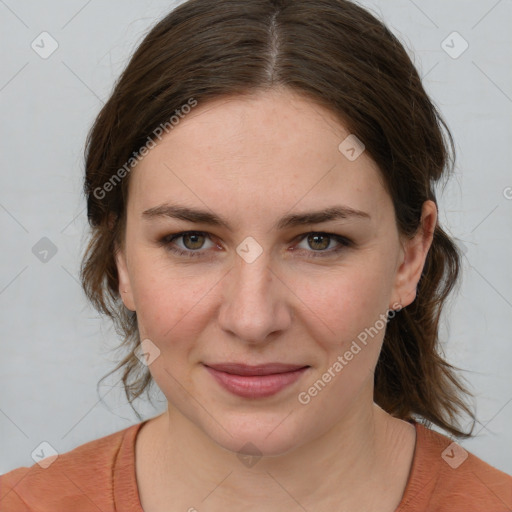 Joyful white young-adult female with medium  brown hair and blue eyes