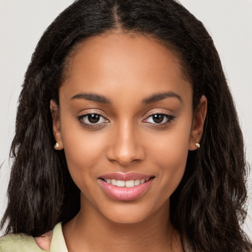 Joyful latino young-adult female with long  brown hair and brown eyes