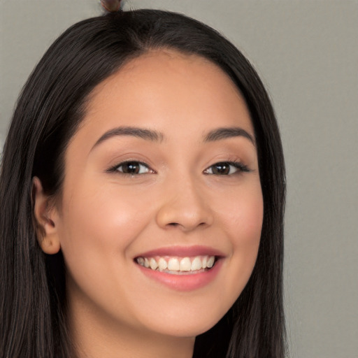 Joyful white young-adult female with long  brown hair and brown eyes