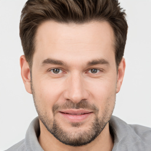 Joyful white young-adult male with short  brown hair and brown eyes